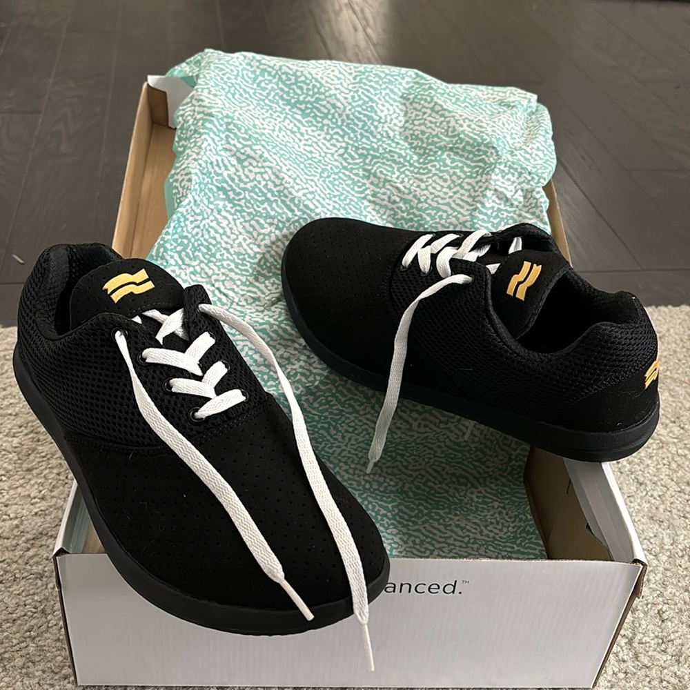 Chill Pill TR. Black with gold symbols, white laces.